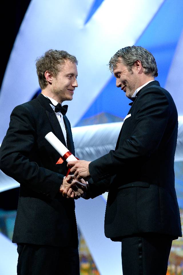 CANNES, FRANCE - MAY 24: Director Laszlo Nemes (L) receives the Grand Prix for his film 'Saul Fia' by actor Mads Mikkelsen at the closing ceremony during the 68th annual Cannes Film Festival on May 24, 2015 in Cannes, France. (Photo by Pascal Le Segretain/Getty Images)