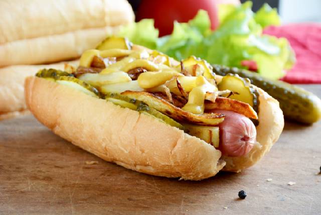 Hot dog with potatoes, pickles and onions