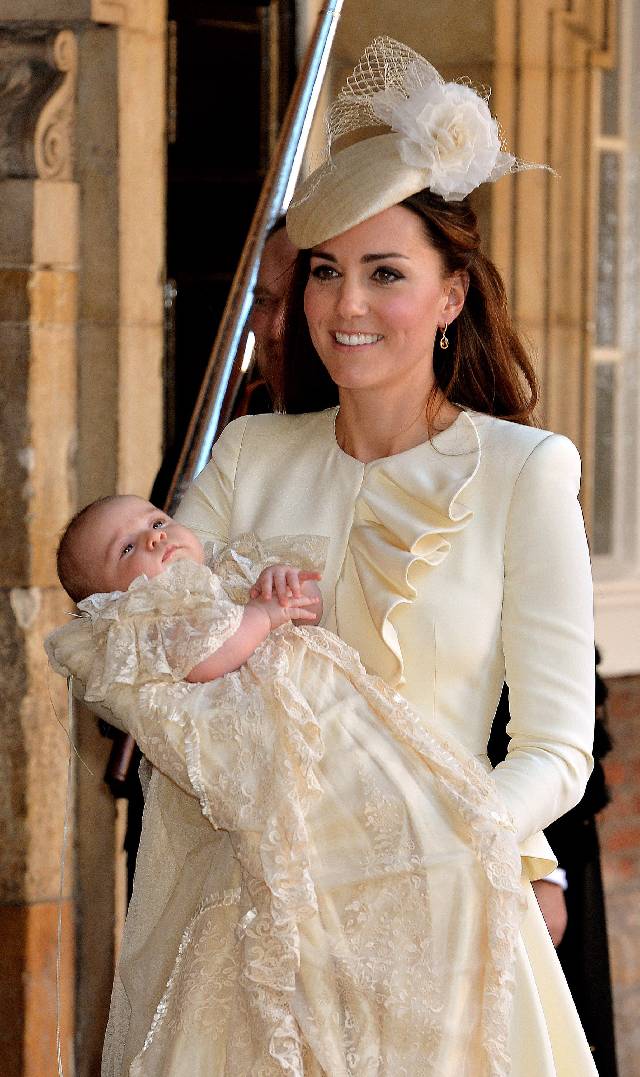 LONDON, ENGLAND - OCTOBER 23: Catherine, Duchess of Cambridge carries her son Prince George Of Cambridge after his christening at the Chapel Royal in St James's Palace, ahead of the christening of the three month-old Prince George of Cambridge by the Archbishop of Canterbury on October 23, 2013 in London, England. (Photo by John Stillwell - WPA Pool /Getty Images)