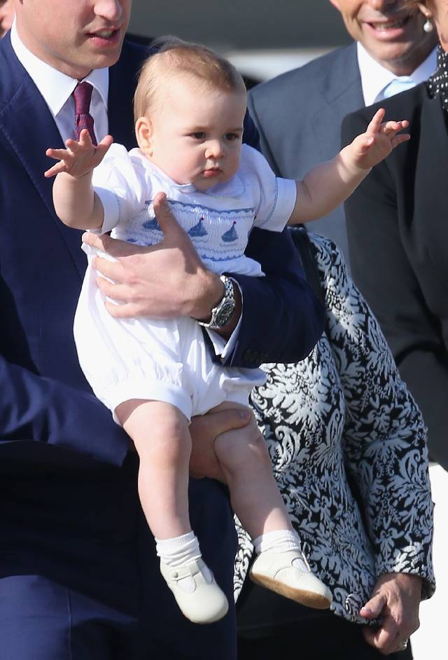 SYDNEY, AUSTRALIA - APRIL 16: Prince William, Duke of Cambridge carries Prince George of Cambridge as they arrive at Sydney Airport on a Australian Airforce 737 aircraft on April 16, 2014 in Sydney, Australia. The Duke and Duchess of Cambridge are on a three-week tour of Australia and New Zealand, the first official trip overseas with their son, Prince George of Cambridge. (Photo by Chris Jackson/Getty Images)